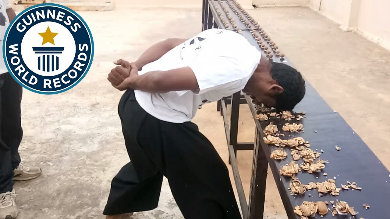 Most walnuts cracked against the head in one minute - Guinness World Records - YouTube