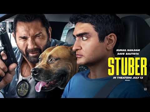 Trailer shot — Stu white-knuckles the wheel while Vic barks orders; score pulses beneath