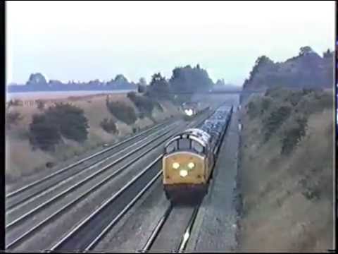 class 37 heads a up freight whilst been overtaken by a 47.Shottesbrooke. mid 80s.