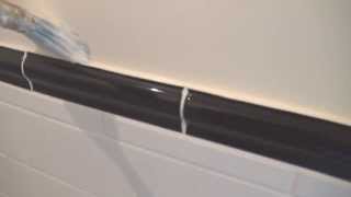 The easy way to cut into tiles when painting bathroom walls