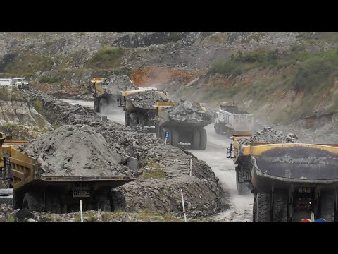 Komatsu HD785, CAT 777D & 777E Dump Trucks Working On A Busy Coal Mines