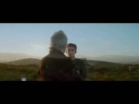 Trailer shot of Jonas on a bicycle rushing beyond the boundary while the score lifts into choir