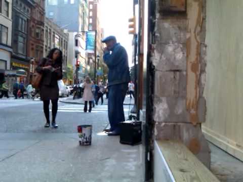 Guy playing blues harmonica at 16th and Chestnut