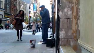 Guy playing blues harmonica at 16th and Chestnut