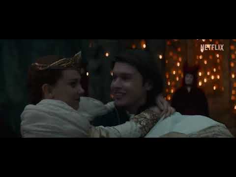 Damsel trailer frame: Elodie facing the abyss — the score thunders then thins to a single line