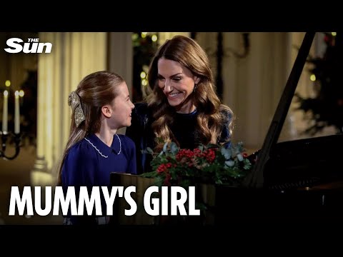 Sweet moment Charlotte gazes up at mum Kate as they play piano at Christmas carol concert