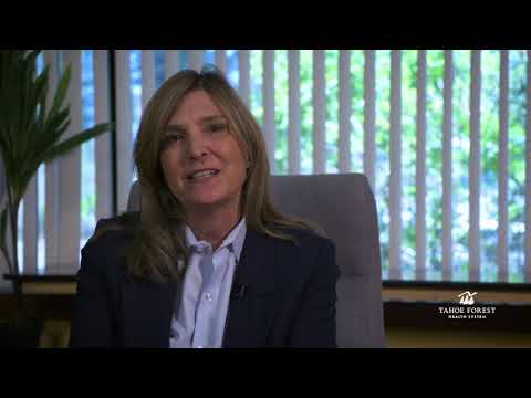 Anna M. Roth, RN, MS, MPH, President and CEO of Tahoe Forest Health System, sitting in front of a window
