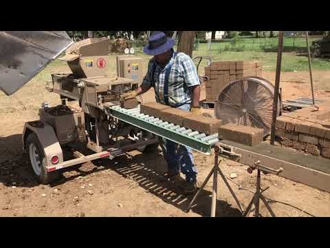 Making compressed earth blocks for barn build