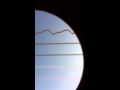 Guitar strings vibrate like sine wave. Just put your camera phone in the sound hole.
