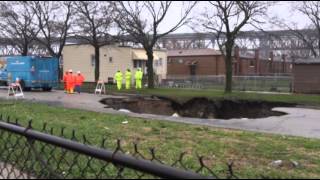Raw: Storm Rips Open Chicago Sinkhole