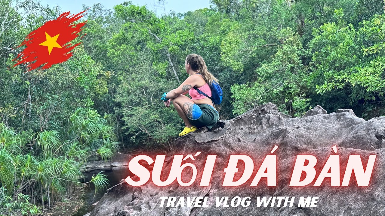 Da Ban Stream features crystal-clear waters flowing over flat, table-like rocks amidst lush greenery.