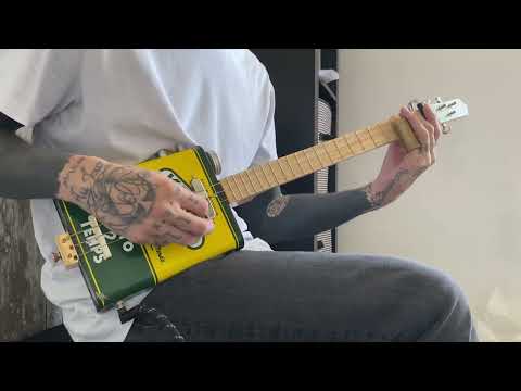 Relaxing slide cigar box guitar oil can