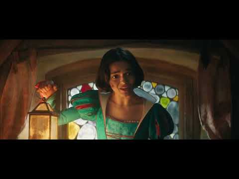 Disney’s Snow White (2025) official trailer still: Snow White turns toward a sunlit castle courtyard as music swells