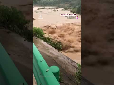 Car swept away by floodwater after bridge collapses in China