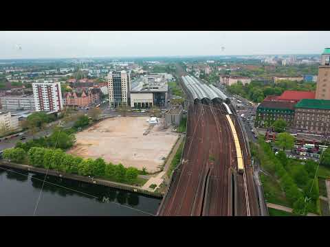 Aerial view of train station. S bahn train driving on multitrack railway line leading on bridge