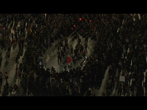 Thousands gather outside Santiago's Moneda Palace on International Women's Day | AFP