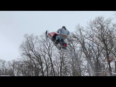 Larry Enticer Jumps Over Bus On Snowmobile