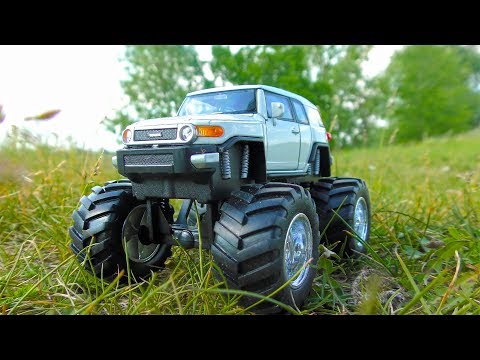 Toy Car on Big Wheels Going Over Various Terrain and Under Water