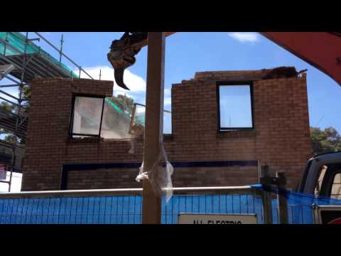 Knocking down wall using excavators