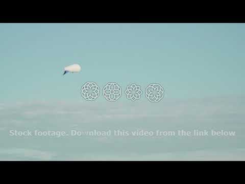 Airships Zeppelin gas helium floating in the sky in sun background on gray evening sky observes the