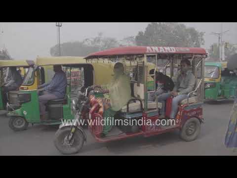 Women driver of E-rickshaw in Red Fort area traffic, Old Delhi: Indian women take to taxi driving