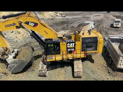 Caterpillar 6015b excavator cuts and loads soil