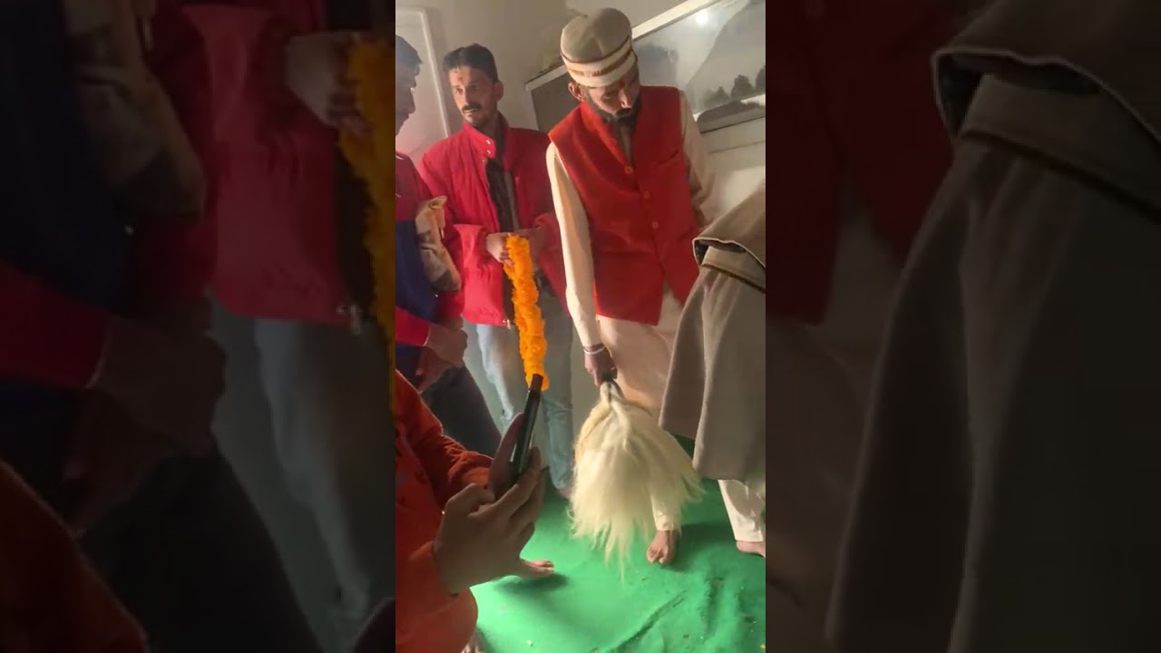 Shri Karmchand Kaushik performs a hereditary ritual by placing the deity’s turban on the chief priest (Muafidar)