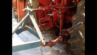 Farmall 230 plowing snow with 6 ft.blade &amp; new top link bracket Fabrication.