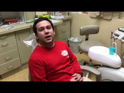 Man in red shirt sitting in dental chair