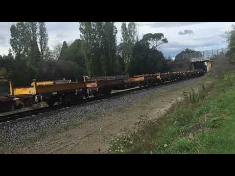 Pacific National steel train at Moss Vale NSW with NR109 (the Ghan) leading