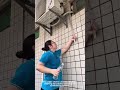 Woman Cleans AC Outdoor Unit for Better Cooling