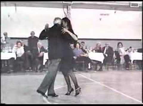  Orlando Paiva  and  Cristina Benavidez  are  dancing  to  the  tango  "  Farol  "