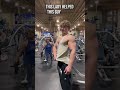 Lady Helps Guy Pose In Gym
