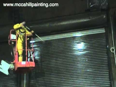 Industrial Power Washing to Clean a Metal Overhead Door - McCahill Painting Company