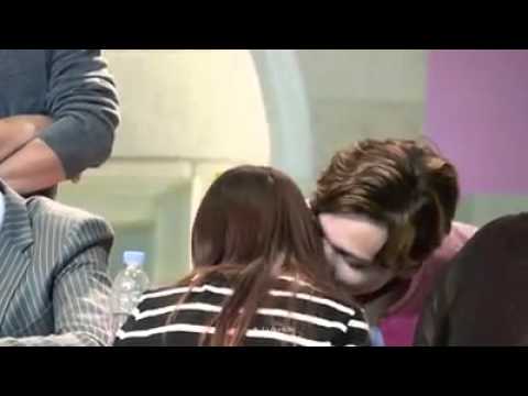 Vernon whispering in his ear to a fan