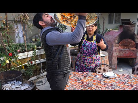 Azerbaijani Woman Cooking Uzbek Pilaf on a Fire in the Village Outdoors