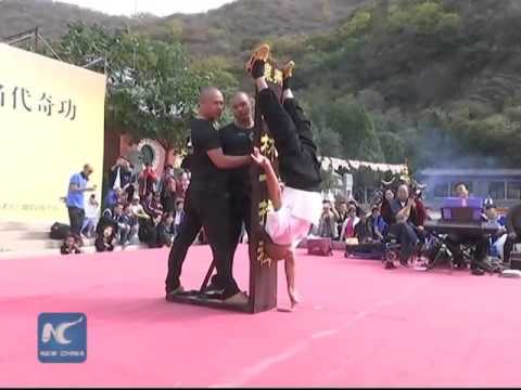 Shaolin monk stands on one finger