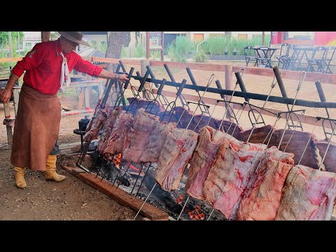 Ancestral barbecue: whole beef ribs roasted in a pit