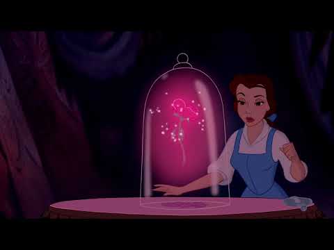 1991 Beauty and the Beast theatrical trailer still: Belle and the Beast framed in golden ballroom light