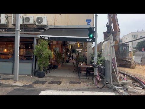 People run for cover in Tel Aviv as warning sirens go off | AFP
