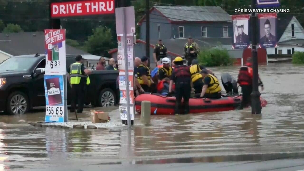 First responders use boats to rescue people from flooded homes, cars in Midwest