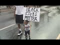 Child holds 'Black Lives Matter' sign at Atlanta protest