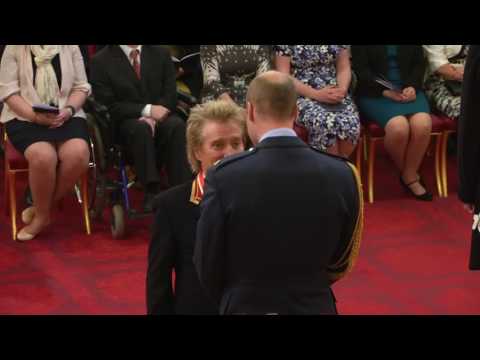 Rod Stewart receiving his knighthood from Prince William