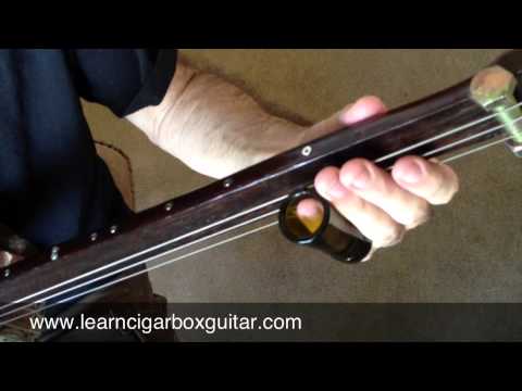 Using a slide on a cigar box guitar - how to avoid unwanted noise