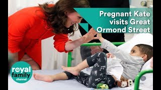 Showing her motherly side! Pregnant Kate comforts sick children