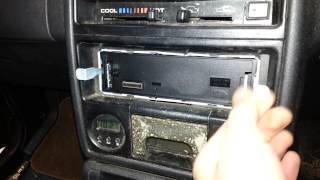How to remove a kenwood radio from its mounting cradle.