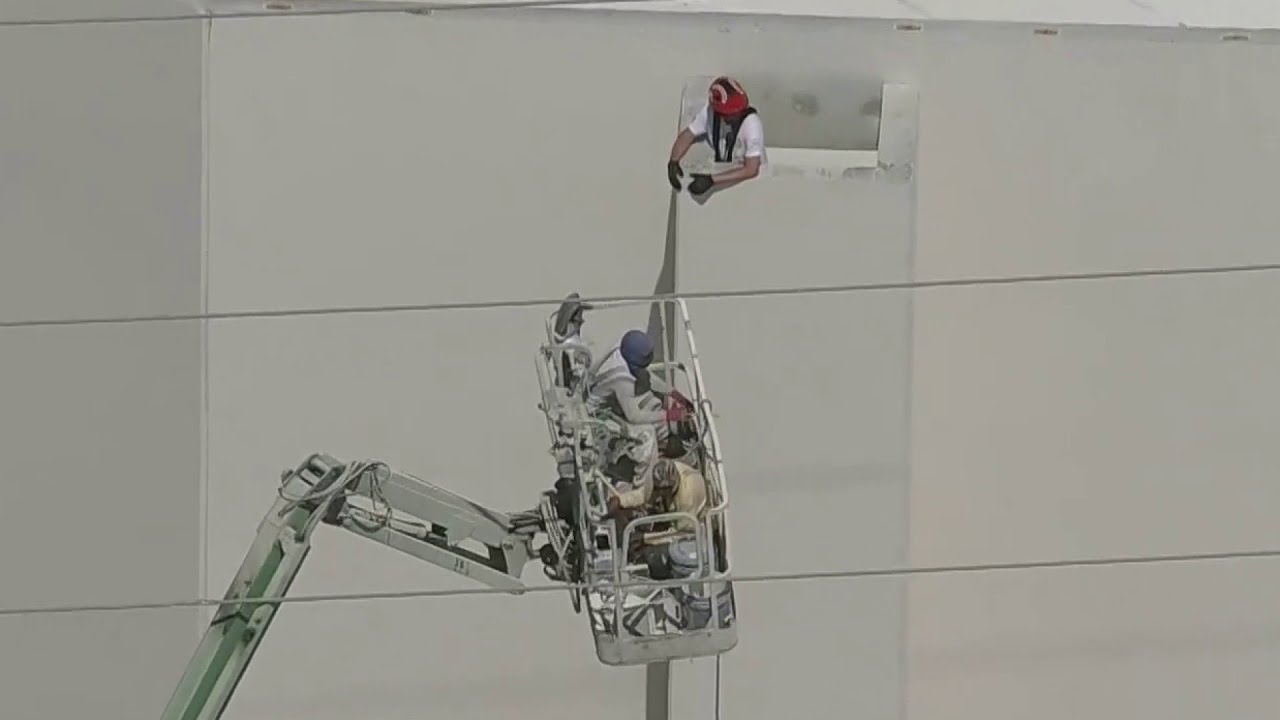 Orange County firefighters work to rescue construction workers stuck 40 feet in the air