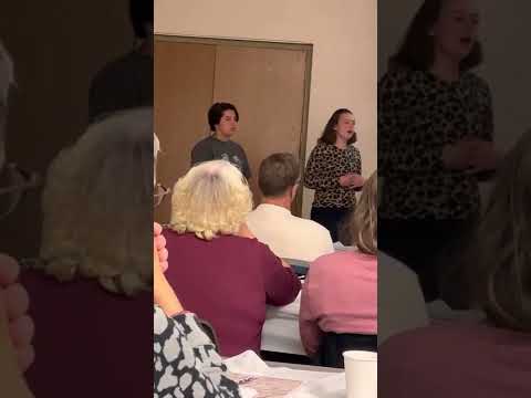 Abigail and Maddie give a presentation about 4-H trips