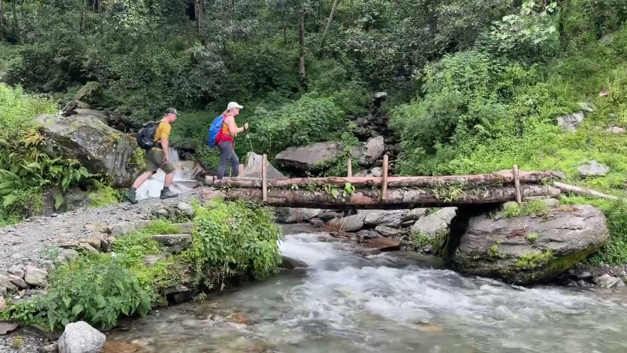 Trekkers Crossing a Wooden Bridge (Annapurna Base Camp Trek)