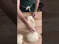Shaping a sourdough batard.
